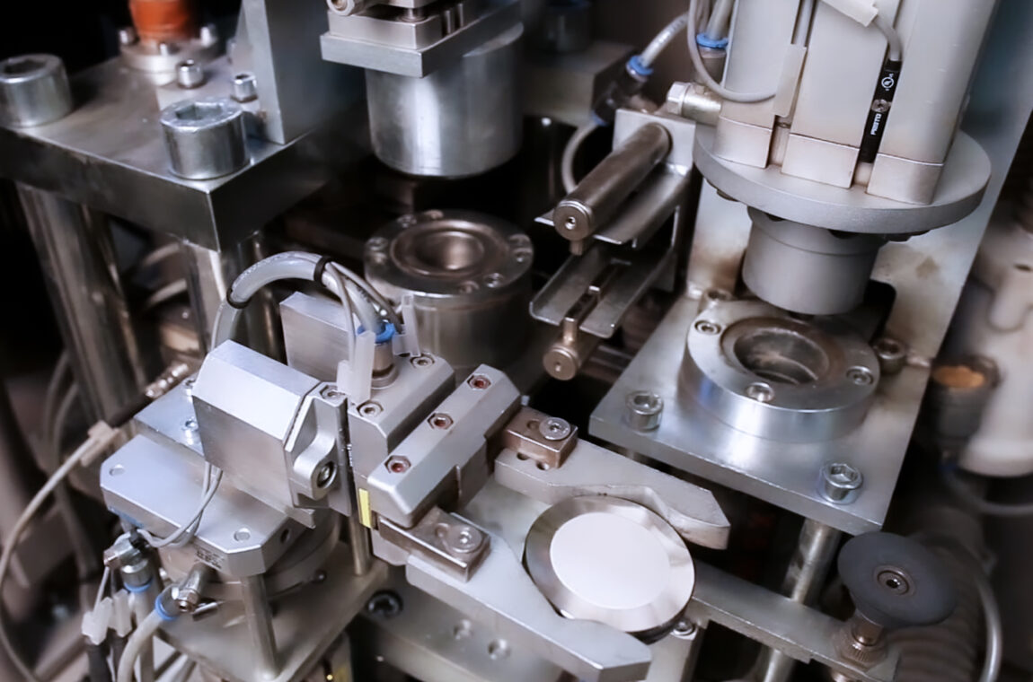 Interior view of the AMP automatic grinding and pressing system - the pressed tablet is cleaned with compressed air