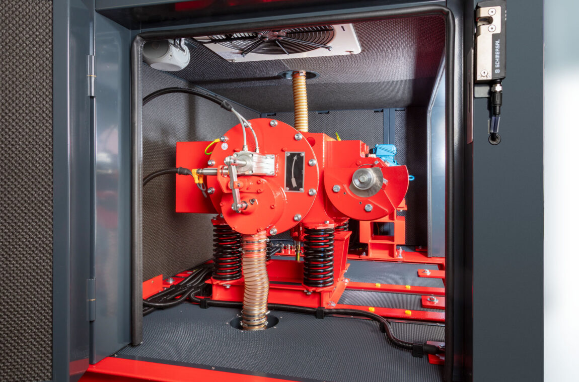 Eccentric vibrating mill ESM 234-1bs View from the open side View through the open door with sound insulation, door lock, unbalance bearing, drive shaft, fan, pneumatic discharge