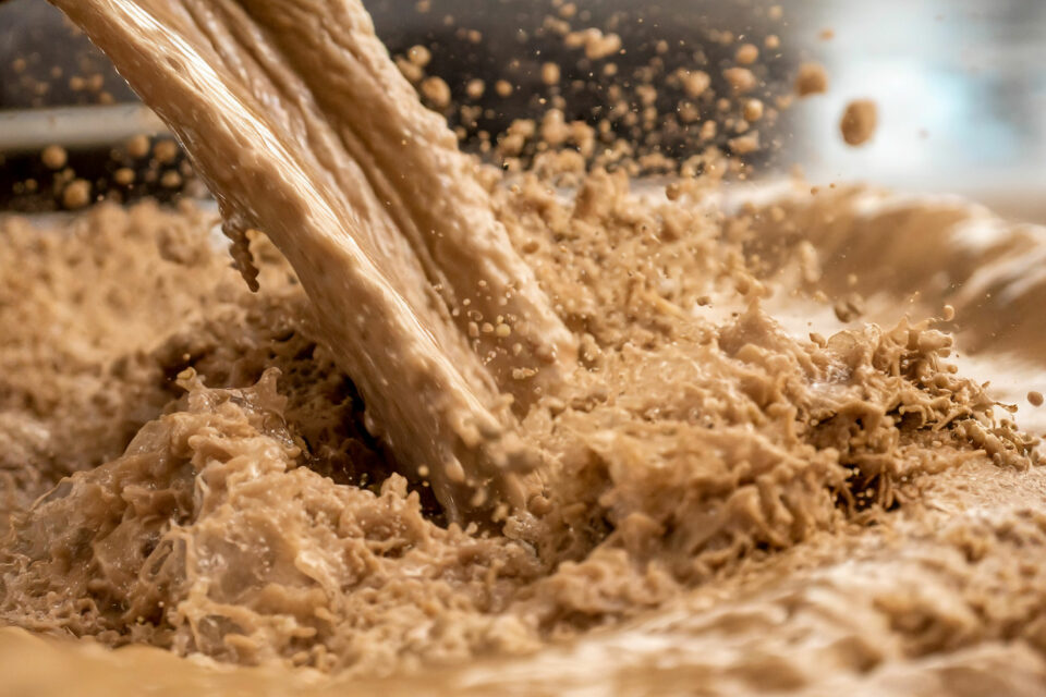 Industry Slurry, brown splashing fluid close-up. Slurry pumps Multotec